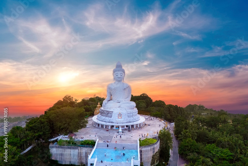 Fotografía Great white marble Buddha statue sits serenely atop a lush Phuket hill top aeria