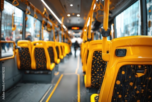 Interior of a modern city bus featuring bright yellow seats with polka dot patterns, showcasing a clean and spacious environment for passengers