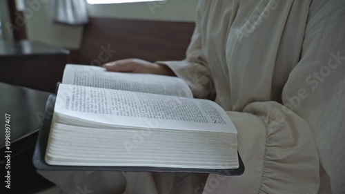 young asian Woman Reading the Bible at indoors daytime