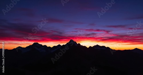 Majestic sunset over mountain peaks with vibrant colors and serene atmosphere at dusk