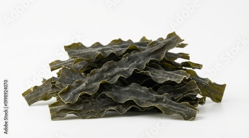 Pile of dried seaweed on a white background, ready for cooking and consumption.