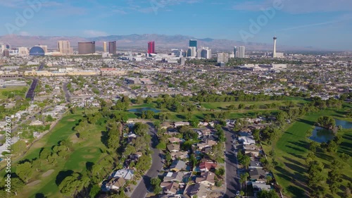 Aerial pullback drone shot of Las Vegas suburbs and city skyline and streets 