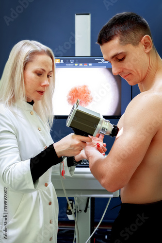 Digital dermatoscopy. Early diagnosis and prevention of skin cancer. Doctor and patient.