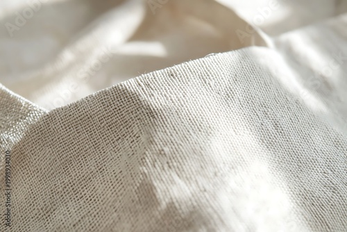Close up of a textured natural fabric with soft light and shadows.