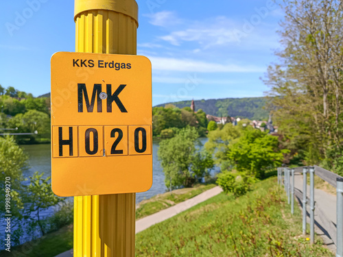фотографія German Sign indicating the location of an underground natural gas line, with a r