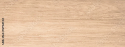 Old paper texture background and antique book cover layered on a natural brown oak wood plank surface with a textured timber grain pattern