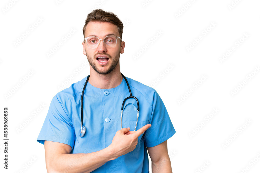 Φωτογραφία Young nurse man over isolated chroma key background surprised and pointing side