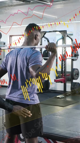 Vertical video: Pro spotting client bracing bar while adjusting for safety in gym red or yellow char
