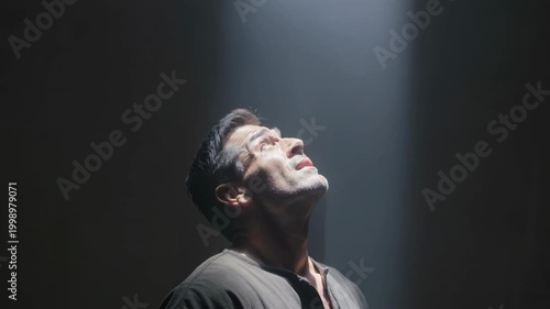 Man gazing upward as a divine light pierces the surrounding darkness, symbolizing revelation, hope, and spiritual awakening