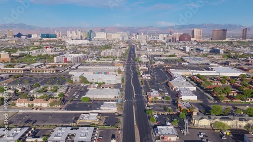 Aerial pullback drone view of Las Vegas suburbs and city skyline and streets 