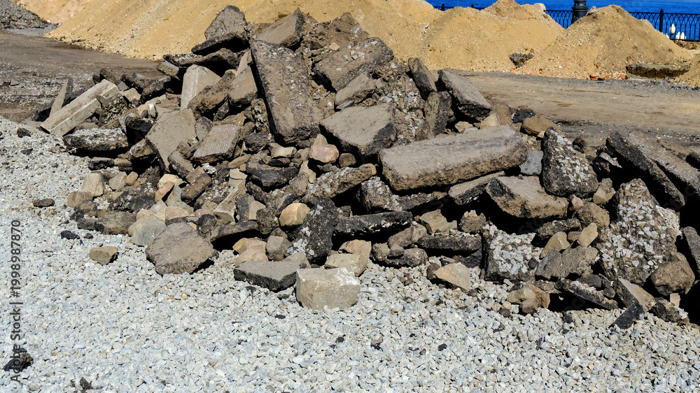 Αυτοκόλλητο Pile of large asphalt chunks after road demolition irregular heap construction d