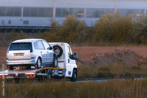 Fotografie Car accident aftermath with vehicle on tow truck
