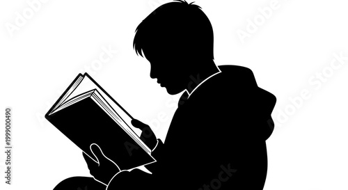 Silhouette of a boy reading a book