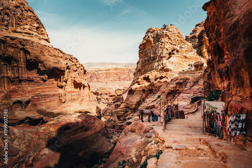 Cuadro en lienzo Hiking trail stairs and narrow sandstone passages leading to the Monastery in Petra, Jordan