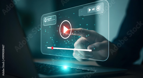 Futuristic Video Streaming Concept with a hand touching a glowing digital play button on a virtual screen above a laptop for technology blogs and digital marketing presentations.