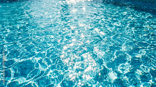 Blue swimming pool water ripples sparkling sunlight