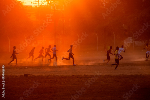 Silhouette people playing football