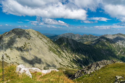Retezat mountains with nearest Papusa mountain peak from Peleaga mountain peak in Romania