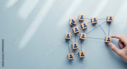 Organizational network structure with connected people icons on wooden blocks, showing team collaboration, stakeholder mapping, social graph, and business communication on a light background