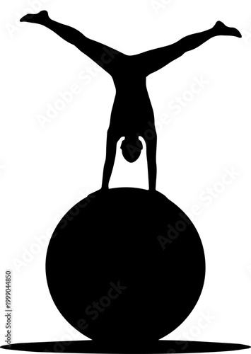 Silhouette of a gymnast performing a handstand on a fitness ball