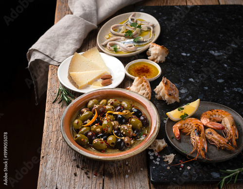 45-degree angle view of Spanish tapas variety presented in a vibrant flat lay arrangement.