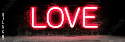 Glowing pink neon LOVE sign on a dark brick wall, casting a vivid romantic light in a moody urban setting.
