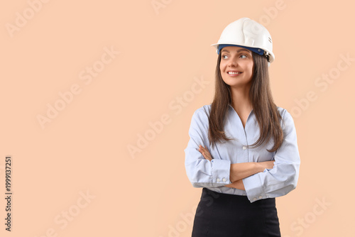 Female engineer on beige ba...