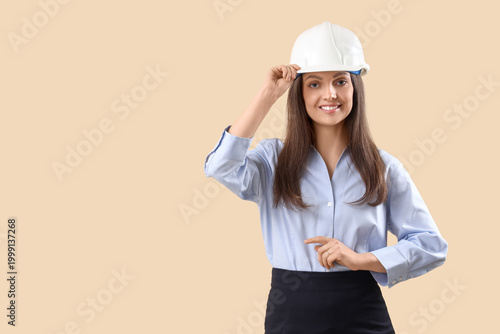 Female engineer on beige ba...