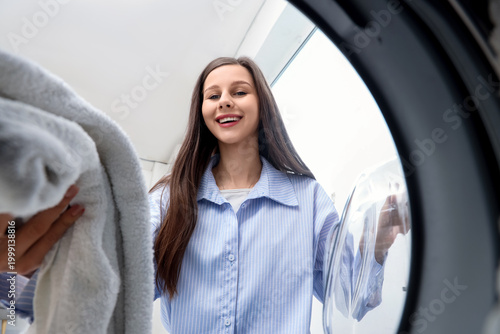 Young woman unloading washi...