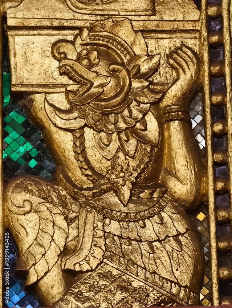 Fototapeta premium Golden Guardian: A close-up view of an intricate golden sculpture. This image showcases the detailed artistry and cultural significance.