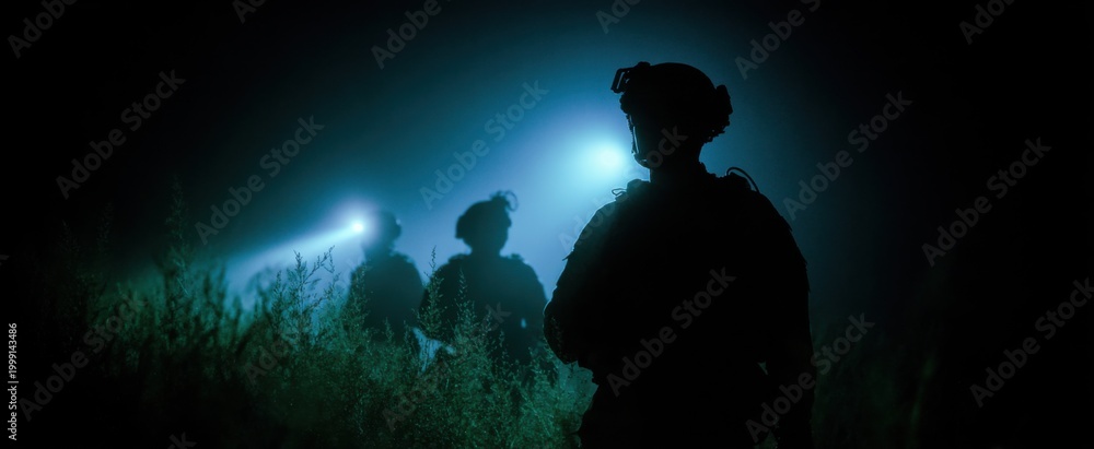 Obraz premium The military unit executing a nighttime low-light combat simulation exercise.