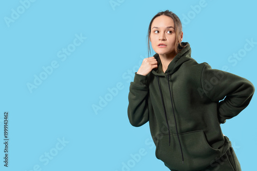 Young woman in green hoodie...