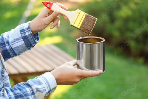 Woman with paint can and br...