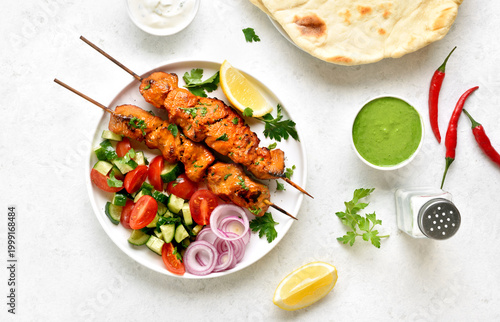 Tandoori chicken skewers served with fresh vegetables