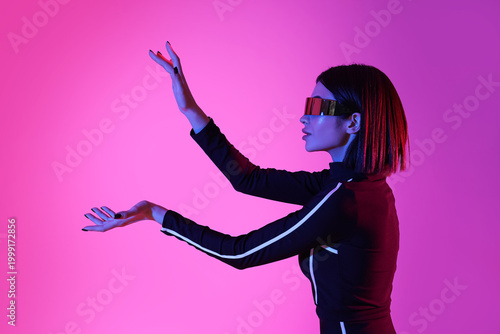 Young woman in VR glasses u...
