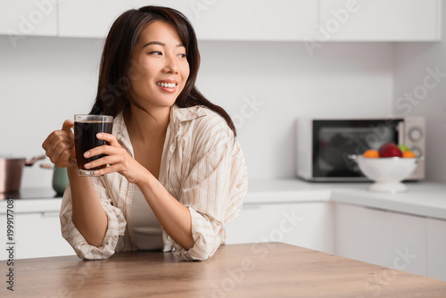 Young Asian woman with cup ...