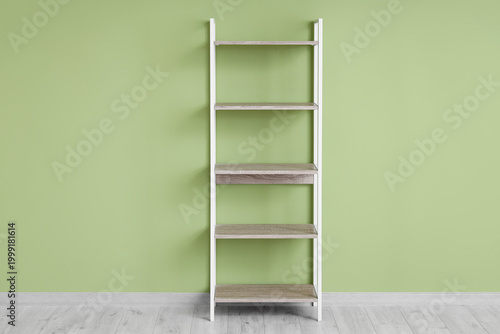 Empty wooden bookshelf near...