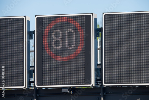 LED digital speed limit sign for variable speed limits showing 80 km/h on German motorway or urban road