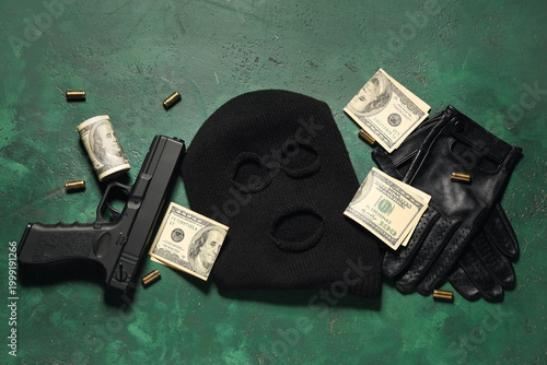 Εκτύπωση καμβά Balaclava with gun, gloves, bullets and money on green grunge background