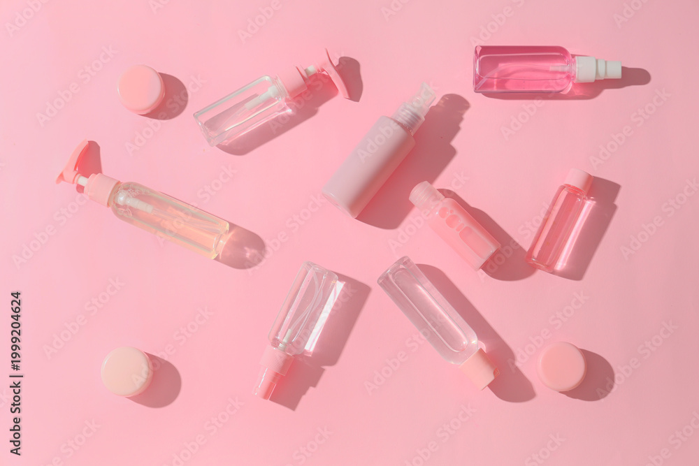 Naklejka premium Composition with different travel cosmetic products on pink background