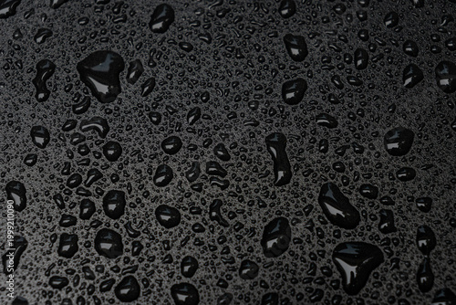 Εκτύπωση καμβά A close-up abstract view of water droplets beading on a dark waterproof surface with glossy reflections and strong texture