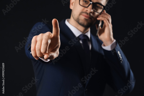 Young businessman with mobi...