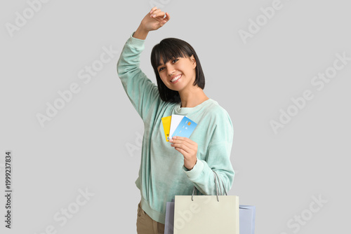 Happy young woman with cred...