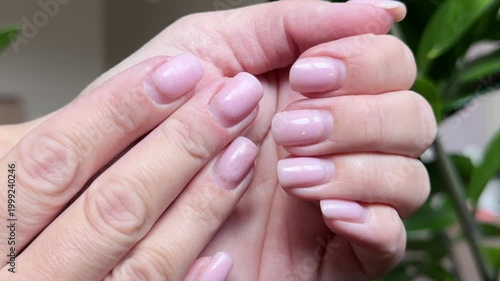 Woman's hands showing grown-out gel nail polish before correction