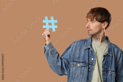 Cool tattooed young man wit...