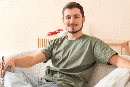 Handsome young man sitting ...