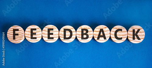 Feedback word symbol. Concept word Feedback on beautiful wooden circles. Beautiful blue background. Business support help feedback word concept. Copy space.