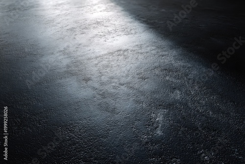 Textured dark surface with a bright diagonal light beam