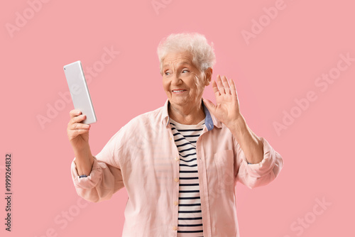Senior woman with tablet co...