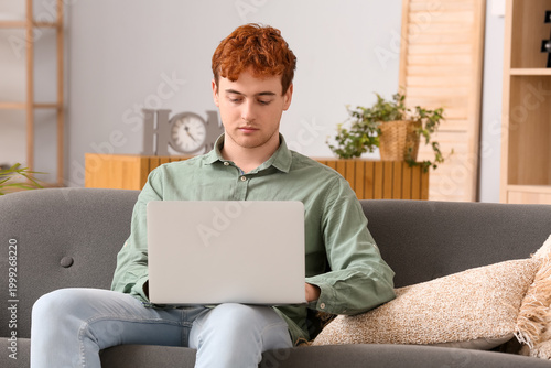 Young man working on laptop...